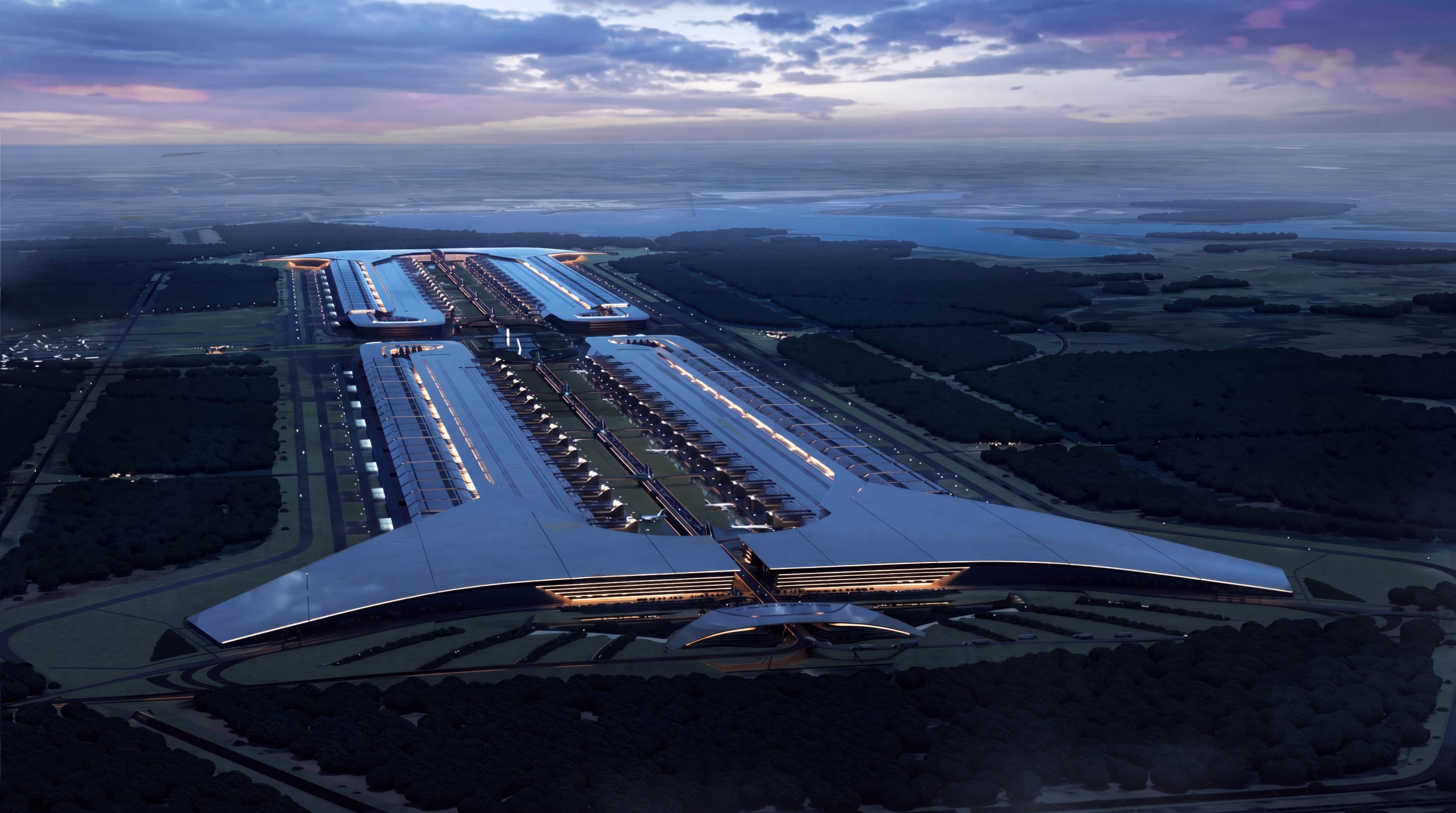 Aerial dusk view of a vast winged campus — TeraFab-scale silicon halls glowing under a violet sky.